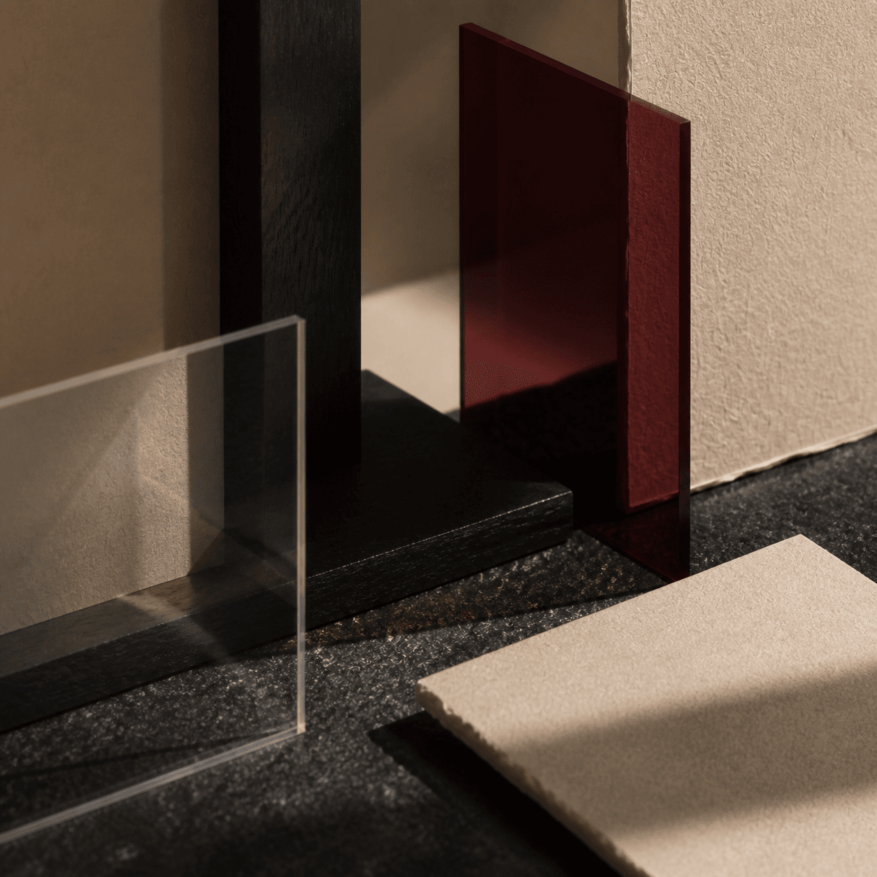 An open-centred arrangement of vellum, stone, glass, ink, and dark wood